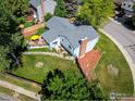 Aerial view of a home with a well-maintained yard and deck with a yellow umbrella at 322 W Harper St, Louisville, CO 80027