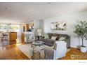 Inviting living room with hardwood floors, a comfortable sofa, and a view into the kitchen at 322 W Harper St, Louisville, CO 80027
