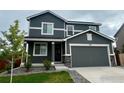 Charming two-story home with a well-maintained yard and attached two-car garage at 348 Vista Cliff Ct, Castle Rock, CO 80104