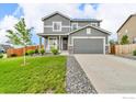 Charming two-story home with a well-manicured lawn and landscaping, showcasing the inviting front porch at 348 Vista Cliff Ct, Castle Rock, CO 80104