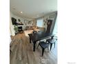 Inviting living space with a fireplace and dining area with wood floors at 348 Vista Cliff Ct, Castle Rock, CO 80104
