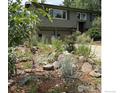 Two story home with lush front garden, a driveway, and an attached two car garage at 3750 Emerson Ave, Boulder, CO 80305