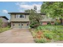 Two story home with lush front garden, a driveway, and an attached two car garage at 3750 Emerson Ave, Boulder, CO 80305