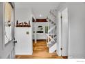 Bright foyer with wood floors, coat closet and staircase leading to the upper level at 3880 Telluride Pl, Boulder, CO 80305