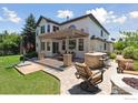 Backyard patio with stone bar and plenty of seating for entertaining at 3931 Stonegrass Pt, Broomfield, CO 80023