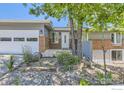Charming home featuring a well-manicured lawn, brick accents, and a two-car garage at 540 Ithaca Dr, Boulder, CO 80305