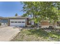 Charming home featuring a well-manicured lawn, brick accents, and a two-car garage at 540 Ithaca Dr, Boulder, CO 80305