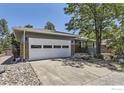 Charming home featuring a well-manicured lawn, brick accents, and a two-car garage at 540 Ithaca Dr, Boulder, CO 80305