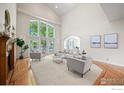 Spacious living room with a wall of windows, hardwood floors, and comfortable seating at 5753 Secrest Ct, Golden, CO 80403