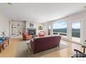 Bright living room featuring a fireplace, built-in shelving, an area rug, and large picture windows with scenic views at 606 Sugarloaf Mountain Rd, Boulder, CO 80302