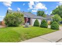 Charming single-Gathering home featuring a well-manicured lawn, mature trees, and a two-car garage at 629 Sumac St, Frederick, CO 80530