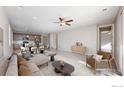 Bright and airy living room with modern furnishings and an open floor plan to the kitchen at 982 Blue Bell Rd, Berthoud, CO 80513