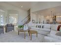 Spacious living room with neutral tones, plush rug, comfortable seating, and an open floor plan at 1030 Turnberry Cir, Louisville, CO 80027