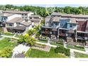 An aerial view of modern townhomes with green landscaping and inviting outdoor spaces at 1044 Maria Ln, Louisville, CO 80027