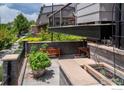 Cozy outdoor patio with stone accents and lush greenery, perfect for relaxation at 1044 Maria Ln, Louisville, CO 80027