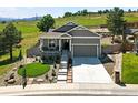 Landscaped home featuring a two-car garage, inviting front porch, manicured front yard and mountain views at 1101 Hillside Ln, Louisville, CO 80027
