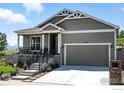 Inviting front exterior with a two-car garage, covered porch, landscaped front yard and concrete steps at 1101 Hillside Ln, Louisville, CO 80027