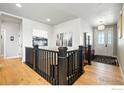 A naturally lit home entryway with wood floors and a view of the stairs at 1101 Hillside Ln, Louisville, CO 80027
