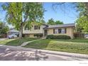 Inviting two-story home featuring a well-kept lawn and a concrete walkway to the front door at 11797 Keough Dr, Northglenn, CO 80233