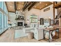 Bright living room featuring a stone fireplace, wood beams, comfortable seating and hardwood floors at 148 Granite Dr, Boulder, CO 80302