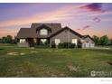 Inviting two-story home with stone accents, manicured lawn, and a convenient three-car garage at 1625 Green Ridge Rd, Berthoud, CO 80513