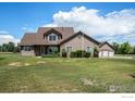 Inviting two-story home with stone accents, manicured lawn, and a convenient three-car garage at 1625 Green Ridge Rd, Berthoud, CO 80513