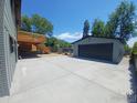 A large detached two car garage and deck with stairs in the backyard at 1843 Spruce Ave, Longmont, CO 80501