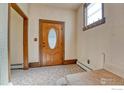 Welcoming entryway with classic patterned carpet and a decorative wood door with an oval glass insert at 1906 Miner St, Idaho Springs, CO 80452