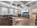 Spacious living room featuring a coffered ceiling, fireplace, and hardwood flooring at 2332 Tabor St, Berthoud, CO 80513
