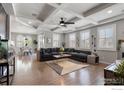 Open-concept living room with coffered ceilings, natural light, and hardwood floors at 2332 Tabor St, Berthoud, CO 80513