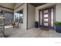 Front porch with seating area perfect for enjoying an evening outdoors at 2737 Heron Lakes Pkwy, Berthoud, CO 80513