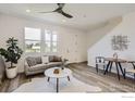 Bright living room with wood floors, a modern sofa, and large windows offering natural light at 2745 Bear Springs Cir, Longmont, CO 80503