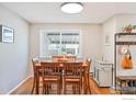 Cozy dining area featuring a wooden table with seating for six and a bright window at 2956 Glenwood Dr, Boulder, CO 80301