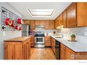 Efficient kitchen with wooden cabinets, stainless steel appliances, and a bright skylight at 2956 Glenwood Dr, Boulder, CO 80301