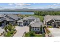 Expansive home aerial view overlooking a lake and golf course with breathtaking mountain views at 3095 Heron Lakes Pkwy, Berthoud, CO 80513