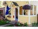 Close up of house entry showing hanging plants and blue door at 310 Judson St, Longmont, CO 80501