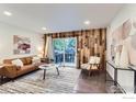 Inviting living room featuring a wood accent wall, comfy seating, and a sliding door to the outside at 3250 Oneal Cir # 10, Boulder, CO 80301