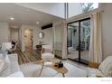 Bright living room with a sliding glass door, neutral decor, and hardwood floors at 3381 Cripple Creek Trl # D14, Boulder, CO 80305