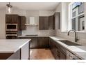 Kitchen featuring stainless steel appliances and dark wood cabinetry at 362 Promenade Dr, Superior, CO 80027