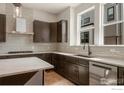 Kitchen featuring stainless steel appliances and dark wood cabinetry at 362 Promenade Dr, Superior, CO 80027