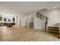Open concept living area with hardwood floors connecting kitchen and staircase at 362 Promenade Dr, Superior, CO 80027