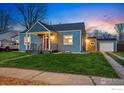 Traditional home with a well-manicured lawn and detached garage at 4720 Perry St, Denver, CO 80212
