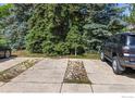 Long driveway with parking and bordered by large trees, provides ample space and privacy for multiple vehicles at 4863 W Moorhead Cir, Boulder, CO 80305
