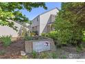 Charming townhouse with well-maintained landscaping, inviting curb appeal, and visible address marker at 4863 W Moorhead Cir, Boulder, CO 80305