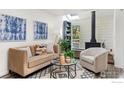 Cozy living room with a modern sofa, patterned rug, and a charming wood-burning stove at 4863 W Moorhead Cir, Boulder, CO 80305
