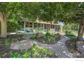 A beautifully landscaped front yard with a brick walkway leading to the home's entrance and mature trees at 623 Mead Ct, Louisville, CO 80027