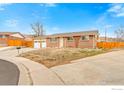 Charming brick ranch-style home with a two-car garage, set on a corner lot at 7162 Quay St, Arvada, CO 80003