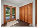 Inviting foyer features wood-framed glass doors and a closet at 7720 Ferris Way, Boulder, CO 80303