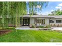 Charming single-story home showcasing a beautifully landscaped front yard and a welcoming entrance with double glass doors at 7720 Ferris Way, Boulder, CO 80303