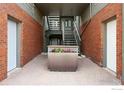 Welcoming building entryway with brick walls, a planter, and access to the stairwell at 854 Walnut St # B, Boulder, CO 80302